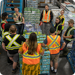 Group of warehouse workers and supervisor