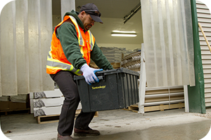 Worker lifting a bin