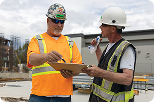 two construction workers speaking